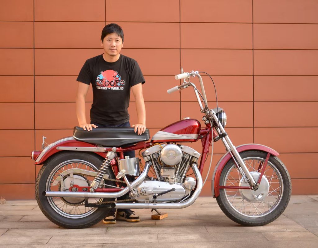 Jing, DWD Garage's founder, standing with his Ironhead Sportster.